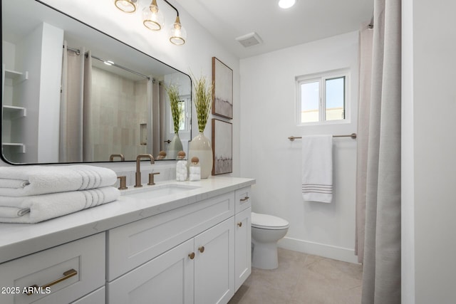 bathroom featuring tile patterned flooring, curtained shower, vanity, and toilet