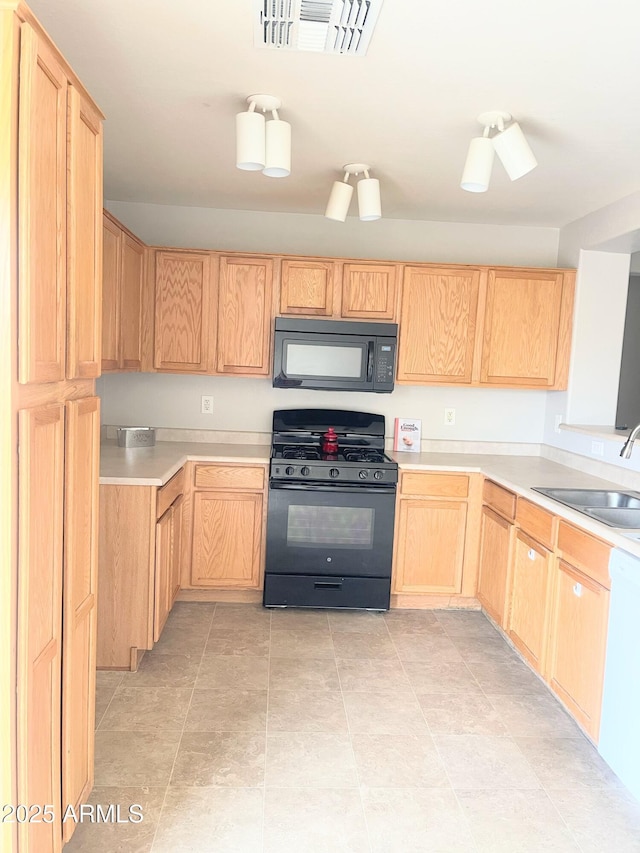 kitchen featuring sink, light brown cabinetry, and black appliances