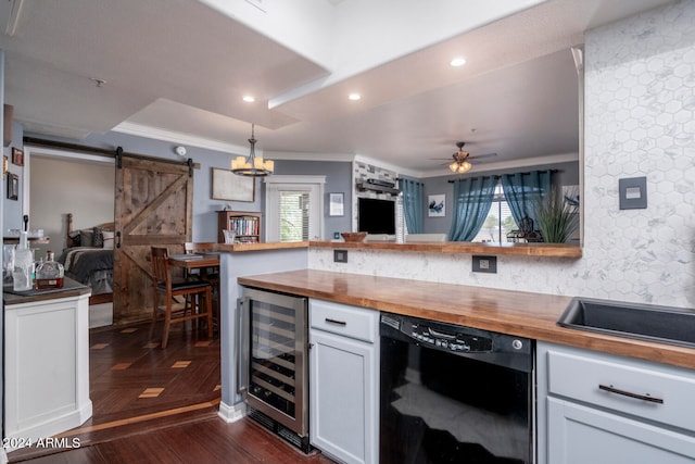 kitchen featuring wine cooler, white cabinetry, black dishwasher, a barn door, and wood counters