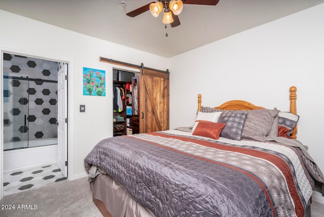 bedroom featuring carpet, ceiling fan, and a barn door