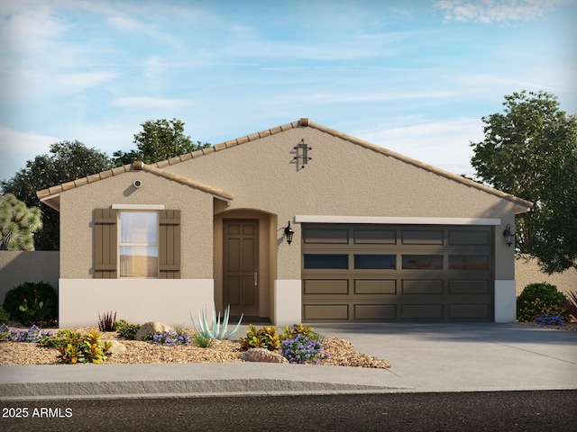 view of front of home with a tiled roof, a garage, stucco siding, and driveway