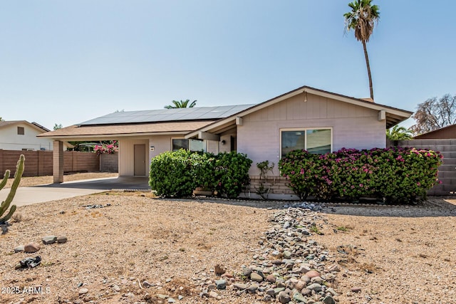 18818 N 12th Ave, Phoenix, AZ 85027 - single story home featuring roof mounted solar panels, brick siding, and a carport