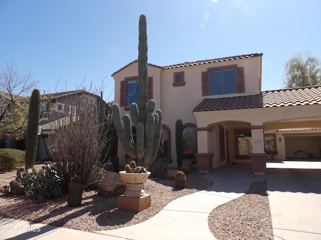 view of front of home featuring a tiled roof and stucco siding