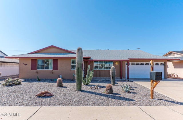 ranch-style home featuring concrete driveway and a garage