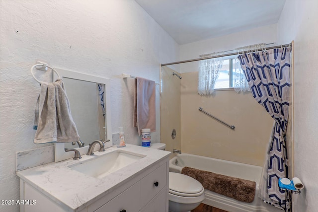 full bathroom with vanity, shower / tub combo, toilet, and a textured wall