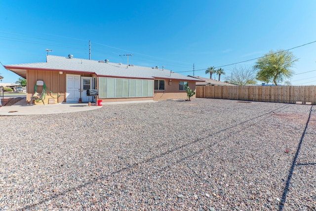 rear view of property with fence