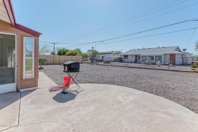 view of patio with grilling area and a fenced backyard