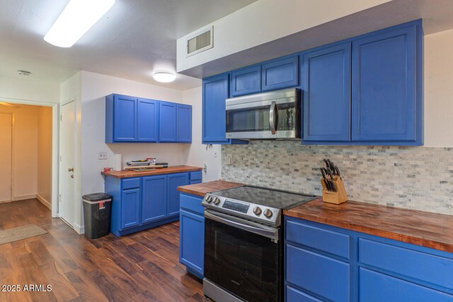kitchen with blue cabinets, visible vents, appliances with stainless steel finishes, and butcher block counters