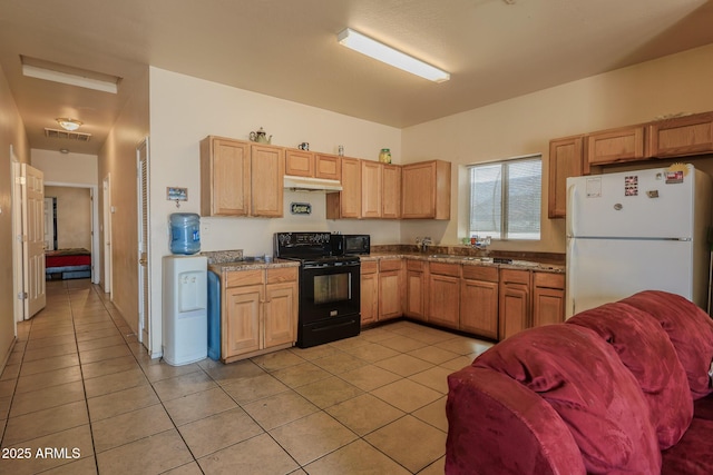 1831 E Pueblo Ave, Phoenix, AZ 85040 - kitchen featuring black appliances, under cabinet range hood, light tile patterned floors, and light brown cabinetry