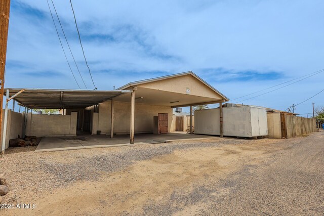1831 E Pueblo Ave, Phoenix, AZ 85040 - view of front facade with fence, driveway, and an outdoor structure