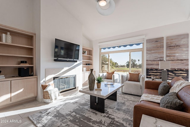 living room with high vaulted ceiling and light wood-type flooring