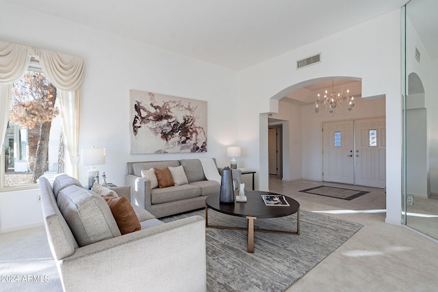 living room featuring an inviting chandelier and light carpet