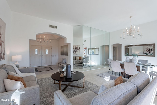 carpeted living room with a notable chandelier