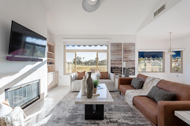 tiled living room featuring vaulted ceiling