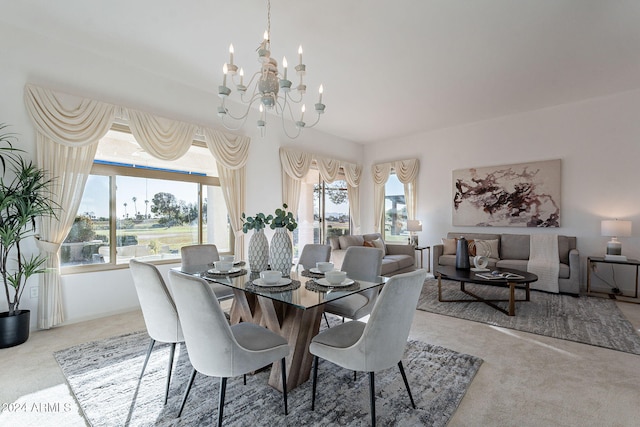 carpeted dining room with a chandelier