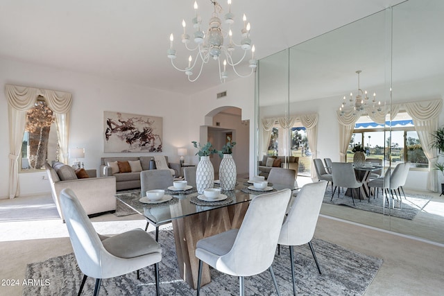 carpeted dining room featuring a notable chandelier