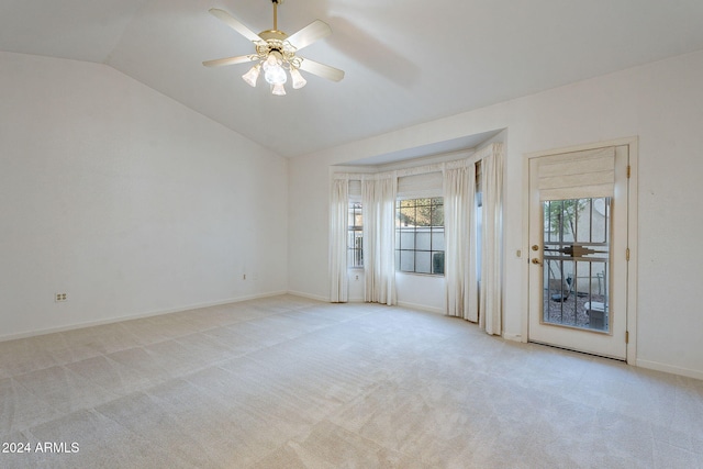 unfurnished room featuring light carpet, ceiling fan, and vaulted ceiling