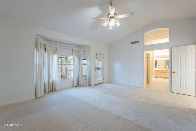 carpeted spare room featuring lofted ceiling and ceiling fan