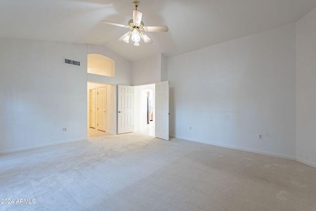 carpeted empty room with lofted ceiling and ceiling fan