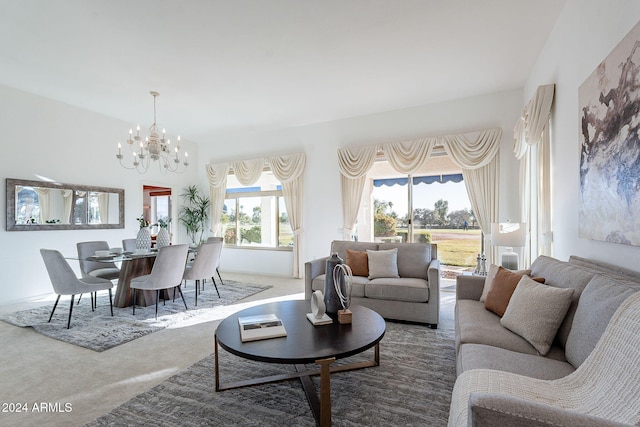 carpeted living room with a chandelier