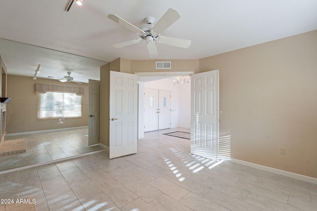 unfurnished room with rail lighting, ceiling fan, and light tile patterned floors