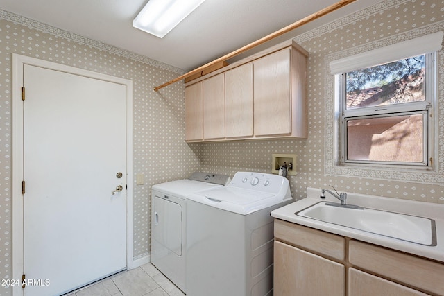 clothes washing area with cabinets, separate washer and dryer, and light tile patterned floors