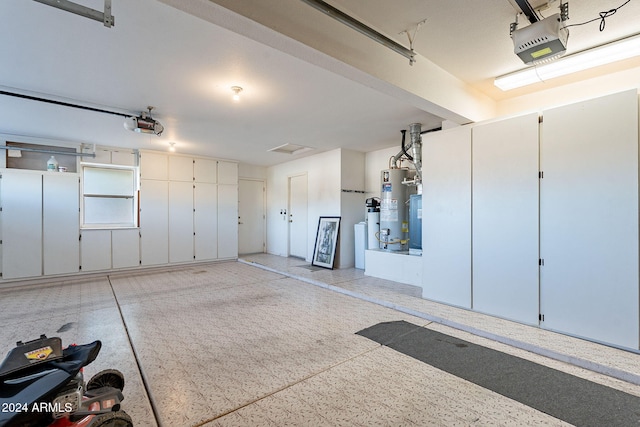 garage with water heater and a garage door opener