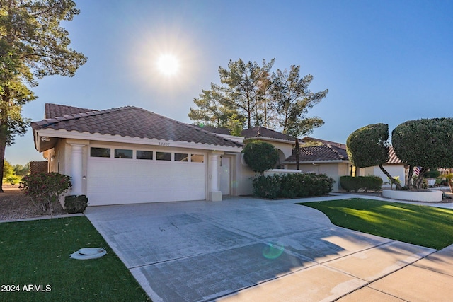 view of front facade featuring a front lawn and a garage