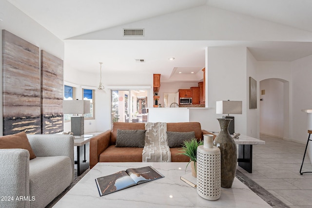 living room featuring lofted ceiling