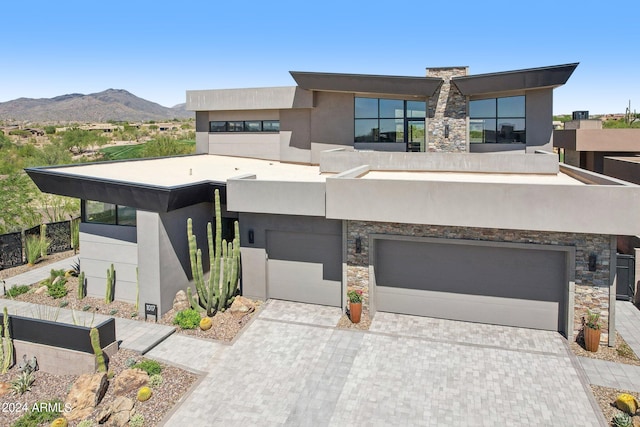 modern home featuring a mountain view and a garage