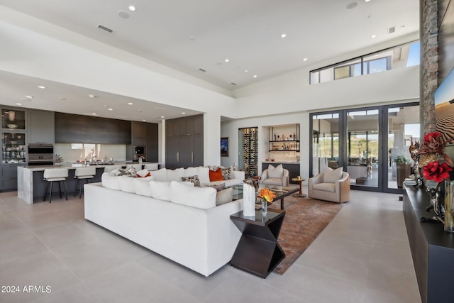 living room featuring a towering ceiling