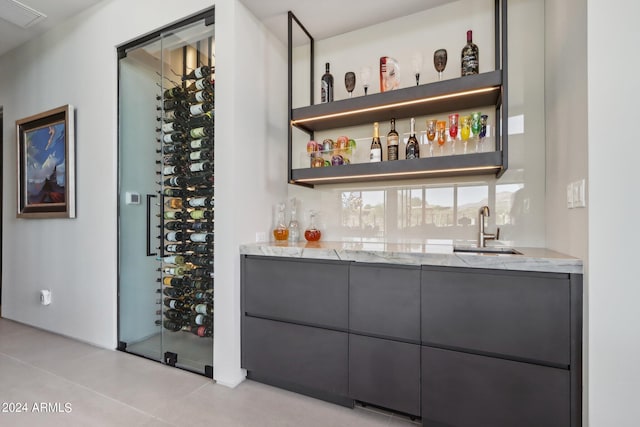 bar with sink and light stone counters