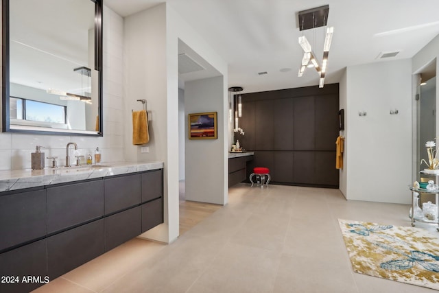 bathroom with vanity and tasteful backsplash