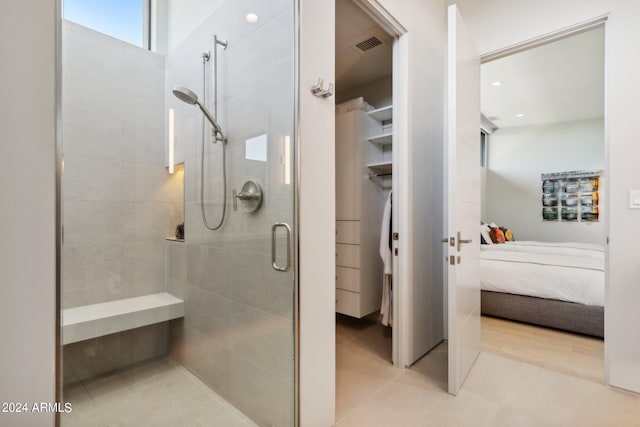 bathroom featuring a shower with door and hardwood / wood-style flooring