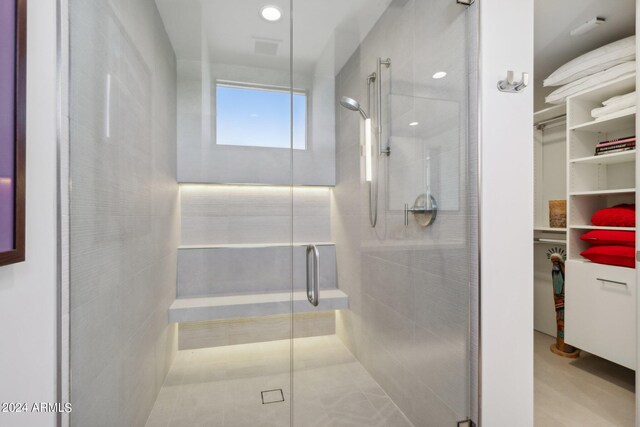 bathroom with vanity, a shower with shower door, and tile patterned flooring