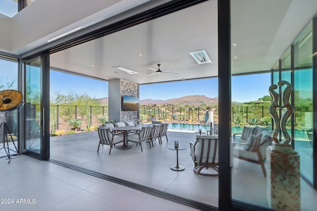 interior space featuring a mountain view and ceiling fan