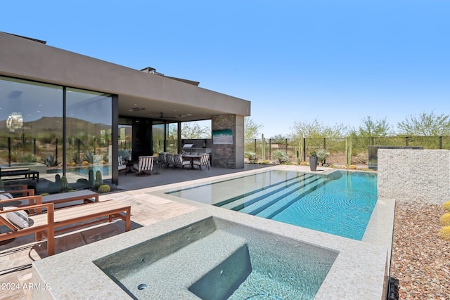 view of swimming pool with an in ground hot tub and a patio area