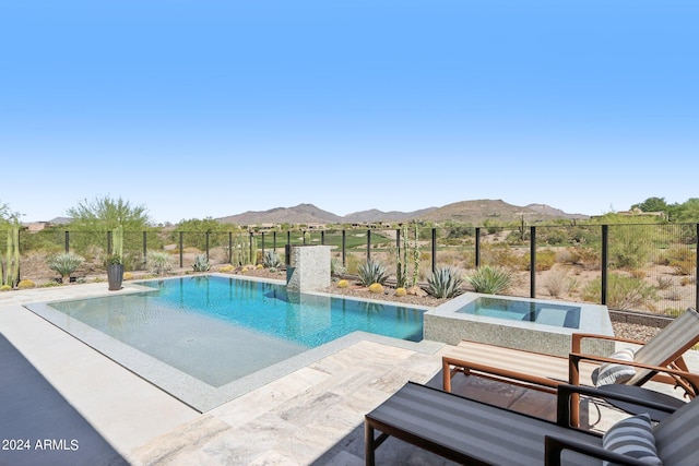 view of pool featuring a patio, an in ground hot tub, and a mountain view