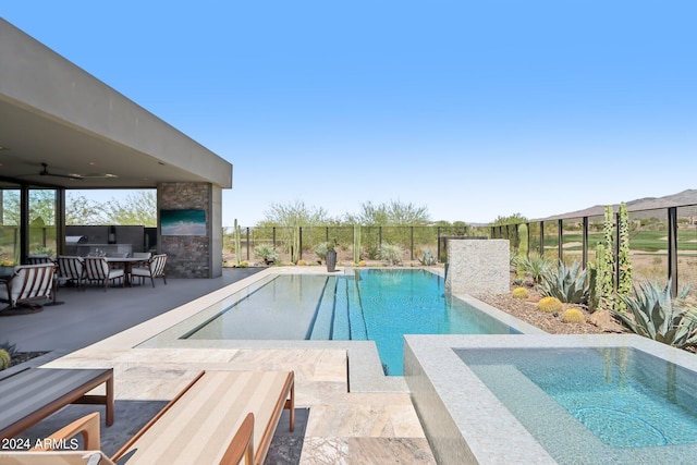 view of pool with ceiling fan and a patio area