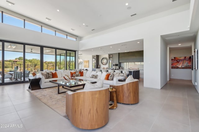 tiled living room featuring a high ceiling