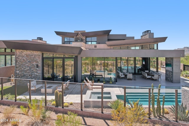 rear view of house featuring a patio and an outdoor hangout area