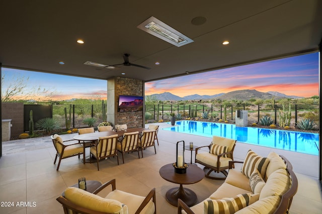 view of patio with outdoor lounge area, ceiling fan, and a fenced in pool