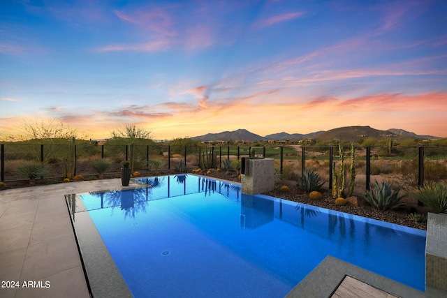 pool at dusk with a mountain view