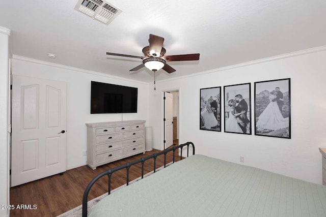 bedroom with ceiling fan, visible vents, ornamental molding, and wood finished floors