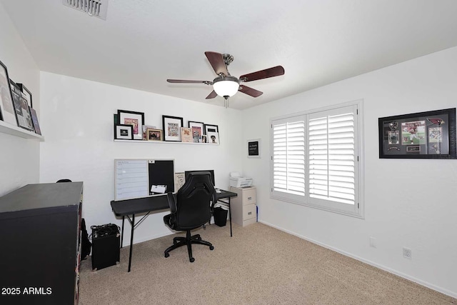 carpeted office space with baseboards, ceiling fan, and visible vents