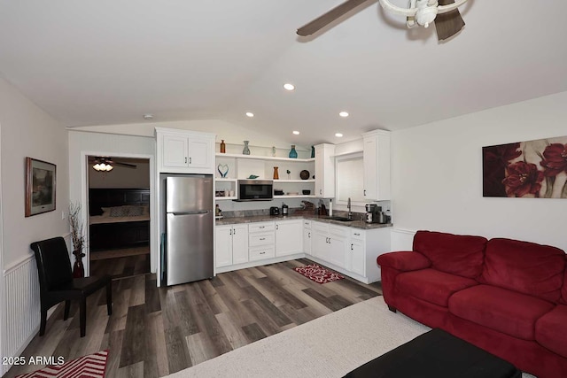living area with dark wood-style floors, recessed lighting, a wainscoted wall, a ceiling fan, and vaulted ceiling