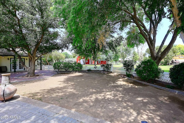 view of community featuring fence private yard