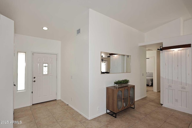 foyer featuring baseboards, visible vents, and light tile patterned floors