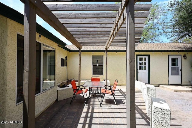 view of patio / terrace featuring a pergola and outdoor dining area