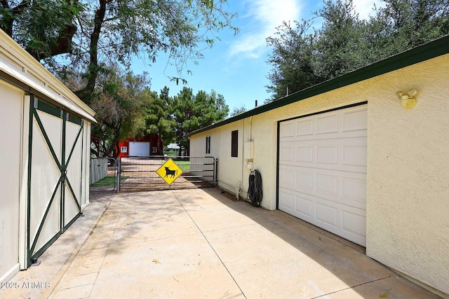 garage with fence and a gate